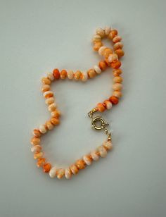 Orange opal beads are hand knotted on orange silk. Gold tone finishings. Necklace length is 16.75 inches. Orange Candy, Opal Beads, Necklace Length, Necklace Lengths, Hand Knotted, Gold Tones, Opal, Beaded Necklace, Jewelry Necklaces