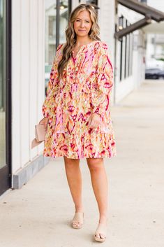 This vibrant pink dress features long-sleeves, a flowy ruffle design, and a smocked waistline for a flattering fit! The v-neckline adds a touch of elegance, while the abstract floral design in shades of pink and orange bring a pop of color to any occasion! This piece is perfect for making a statement and standing out from the crowd! Self - 97% Polyester, 3% ElastaneLining - 100% Polyester Pink V-neck Dress With Elastic Waistband, Pink Spring Dresses With Elastic Waistband, Chic Pink Dress With Elastic Waistband, Pink Dress With Elastic Waistband For Brunch, Shades Of Pink And Orange, Abstract Floral Design, Ruffle Design, Tunic Sweatshirt, Jumpsuit Party