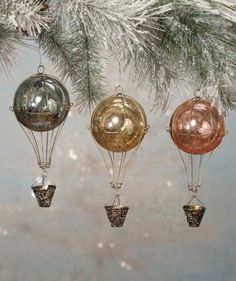 three hot air balloons hanging from a christmas tree