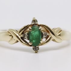 an oval shaped emerald and diamond ring