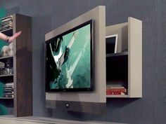 an entertainment center with a flat screen tv mounted on the wall