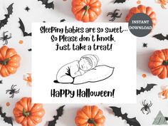 a greeting card with an image of a baby sleeping on a pillow surrounded by halloween decorations