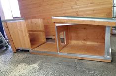 an unfinished kitchen with wood paneling and stainless steel trim