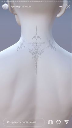 the back of a woman's neck with an intricate cross tattoo on her chest