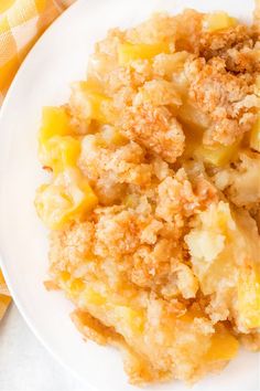 a close up of a plate of food with potatoes and crumbs on it