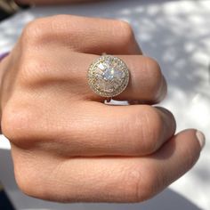 a woman's hand with a diamond ring on it