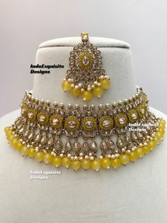 Antique Gold Polki Necklace Set comes with Stud earrings and tikka / Indian Jewelry/ High Quality Kundan and Polki Jewelry/ Bollywood Jewelry/Wedding Jewelry/Yellow color  All items are shipped from Brampton, Ontario, Canada. If you need your item by a certain day, please reach out to us for express delivery option before placing the order so that we can update the shipping for you. Standard shipping/delivery timeline Below are the delivery timeline estimates once the order ia shipped ---> USA delivery timeline * 3-5 business days to major urban centers in USA. It may take 1-2 days extra to remote locations ---> Canada delivery timeline  * 2-3 business days - GTA  & Montreal  * 2-4  business days - Rest of Ontario/Quebec * 3-6 business days-  Rest of Canada    ---> Europe/Middle East timel Gold Temple Jewelry Style Lehenga For Parties, Festive Yellow Jewelry Sets As A Gift, Festive Yellow Jewelry Sets As Gifts, Festive Yellow Jewelry Sets For Gift, Gold Temple Jewelry Lehenga For Party, Heavy Gold Lehenga For Party, Festive Yellow Bridal Necklace For Celebration, Temple Jewelry Style Bridal Necklace In Yellow, Yellow Jewelry For Party Festivals