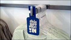 this just win luggage tag hanging on a coat rack in a closet or closet room