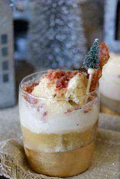 a dessert in a glass with a small christmas tree on top