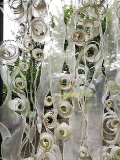 an image of a window that is decorated with white flowers and spirals on it