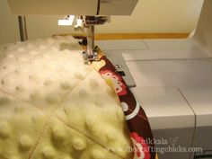 the sewing machine is working on the fabric