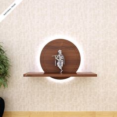 a wooden shelf with a skeleton figurine on it and a potted plant next to it