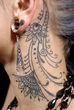 a close up of a person with a tattoo on their neck and behind the ear