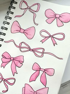 a drawing of pink bows on white paper