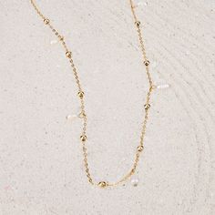 To The Sea Gold Body Chain | Wanderlust + Co Summer Lariat Necklace With Adjustable Chain, Minimalist Summer Necklace With Adjustable Chain, Dainty Pearl White Chain Necklace With Adjustable Chain, Pearl Chain Necklace For The Beach, Beaded Chain Strand Necklace, Adjustable Minimalist Pearl Necklace With Beaded Chain, Adjustable Pearl Necklace With Delicate Chain, Gold Beaded Necklaces With Adjustable Chain For Beach, Summer Gold Pearl Necklace