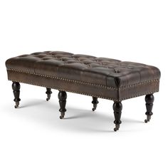 a brown leather bench with wooden legs and nail polishing on the bottom, sitting in front of a white background