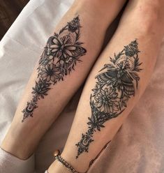 two women with tattoos on their legs sitting next to each other