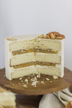 a cake that is sitting on top of a wooden platter with slices taken out of it