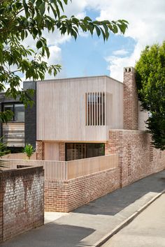 a brick building with a wooden fence around it