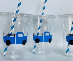 two plastic cups with blue and white striped straws in the shape of a truck