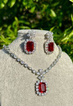 Handmade  Style: Necklace and Earrings Set Material: Platinum Plated, Lab Simulated Ruby and White Sapphire Stones Imported Please Note: This necklace and earrings are sold as a set. Item Number: 7078R Luxury Elegant Ruby Beaded Necklaces, Luxury Vintage Ruby Necklace, Elegant Ruby Jewelry Sets With Matching Earrings, Wedding Drop Earrings With Stones, Ruby Necklaces With Matching Earrings For Gift, Ruby Necklace With Matching Earrings As A Gift, Ruby Necklaces With Matching Earrings As Gift, Formal Pendant Jewelry With Stones, Luxury Red Dangle Jewelry