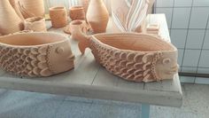 some pottery is sitting on a table in a room