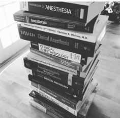 a stack of books sitting on top of a wooden floor