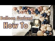 balloon garland and how to make it look like an arch in a bedroom with white bedding