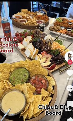 a table topped with lots of food and drinks next to plates of chips and dips