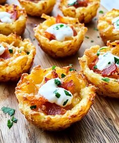 small appetizers are arranged on a wooden board