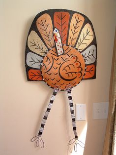 a paper turkey is hanging on the wall