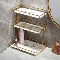 a bathroom with marble and gold accents