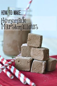 homemade marshmallows stacked on top of each other next to a jar of chocolate milk