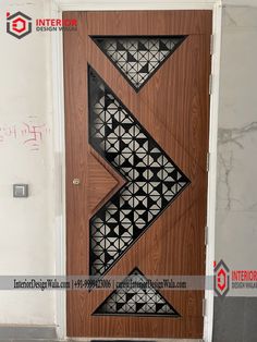 a wooden door with an arrow design on the front and side panels inlayed to it