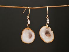 These beautiful earrings are created using Small Oyster  shells.  Hook earrings gold finish. They have a stunning Pearl accent stone on a silver hook.  Made by yours truly,               Becca Gold Shell With Matching Earrings Gift, Pearl Drop Shell Earrings For Gift, Gold Shell Pearl Earrings As Gift, Gold Shell Earrings With Ear Wire As Gift, Gold Shell Pearl Earrings For Gifts, Gold Shell Earrings With Ear Wire For Gift, Gold Shell Ear Wire Gift, Gold Pearl Earrings With Shell - Gift, Gold Pearl Drop Earrings With Shell