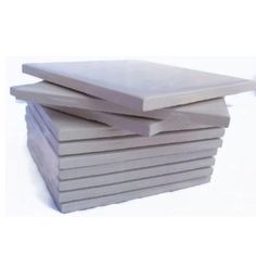 a stack of gray tiles sitting next to each other on top of a white surface