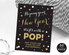 a black and gold new year's card with the words pop on it