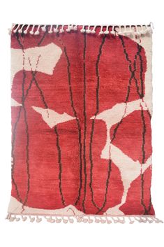 a red and white rug with fringes on the bottom, in front of a white background