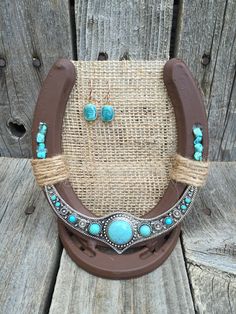 a cowgirl necklace and earring set made out of rope with turquoise stones on it