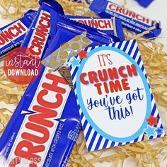 some candy bar wrappers are laying on top of shredded paper and have the words, it's crunch time you've got this