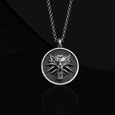 White Wolf Necklace Introducing our exquisite Wild Wolf Sterling Silver Handcrafted Necklace, a must-have accessory for any fan of the iconic video game series. This attractive locket necklace has a stylish and enigmatic design. Crafted with meticulous attention to detail, the pendant displays a personalized white wolf emblem symbolizing strength and loyalty. Made from high quality sterling silver, this necklace is not only a stunning fashion statement but also a heartfelt Christmas gift for your loved ones. Elevate your style and embrace your inner warrior with this extraordinary piece of jewelry. Product Code: FRYKRT203 Product Name: White Wolf Necklace Metal: Handmade oxidized 925 Sterling Silver Necklace (Can also be produced in 14/18/22 carat gold upon request. Weight: 18-24 gram 🎁 G Themed Metal Pendant Jewelry, Themed Silver Stainless Steel Jewelry, Silver Metal Jewelry Gift, Collectible Themed Jewelry Pendant, Collectible Themed Pendant Jewelry, Themed Stainless Steel Jewelry As Gift, Silver Themed Pendant Jewelry, Themed Silver Pendant Jewelry, Themed Round Pendant Jewelry As Gift