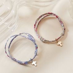 Celebrate precious moments and new beginnings with our Mini Cross Charm Liberty Bracelet. Choose between 5 Liberty prints to pair with your choice of 18K Champagne Gold Plated or 925 Sterling Silver mini cross charm. Create a unique gift for a Christening or Communion with the prints of Liberty.&nbsp;18K Champagne Gold Plated and 925 Sterling SilverMini Cross: 0.3 x 0.2Liberty braid with fully adjustable sliding knot fasteningSent with love in a complimentary gift boxChildren’s Warning: please note, this piece of jewelry is not a toy. We advise you to not leave your child unattended when wearing their special piece as small and delicate charms can be a choking hazard if ingested. Spiritual Cross Charm Bracelet Gift, Liberty Bracelet, Bracelets Liberty, Mini Cross, Sliding Knot, Liberty Print, Cross Charms, Champagne Gold, Precious Moments