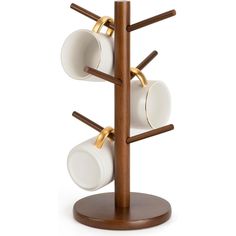 three cups and two saucers on a wooden stand