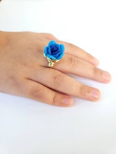 This kids ring is a size 5. Perfect fit for my 4 year old. The rose bead is made of a soft plastic, so no need to worry about injury. Wire wrapping is a gold color plated silver. So much fun to play dress up with. The kids love these! Adjustable Blue Flower Ring, Adjustable Blue Flower Ring For Gifting, Adjustable Blue Flower Ring Gift, Kids Ring, Play Dress Up, Kids Rings, Rose Ring, Play Dress, Soft Plastic