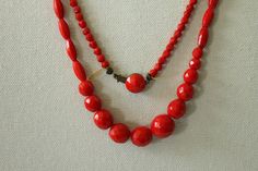 Vintage red glass beaded necklace. This beautiful red hot necklace features faceted glass beads of multiples shapes and sizes. This is a long and hefty necklace, 52 inches! Push tab closure with a larger round cabochon.  No markings Measurements: 52" length Good vintage condition. This stringing on this necklace is showing, possible stretched with spaces in between the beads towards the clasp. Wear is typical use and the age of this necklace Red Double Strand Faceted Beaded Necklace, Red Double Strand Faceted Beaded Necklaces, Red Double Strand Beaded Necklace With Faceted Beads, Hot Necklaces, Mid Century Jewelry, Necklace Long, Retro Mid Century, Glass Bead Necklace, Faceted Glass