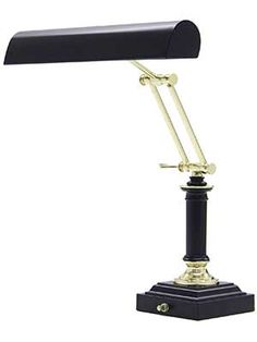 a black and gold desk lamp on a white background