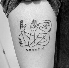 a person with a tattoo on their thigh that says chaotic and two hands holding each other