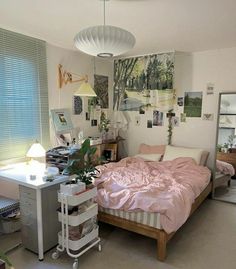 a bed room with a neatly made bed next to a desk and window covered in pictures