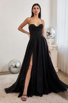 A woman stands confidently in a black, sequined gown with a high slit, adorned with thin straps. The backdrop features a bright room with a disco ball and soft lighting. Plus Size Gowns Formal, Cute Bridesmaid Dresses, Cinderella Divine, Prom Dress Plus Size, Spaghetti Strap Prom Dress, Corset Dress Prom, Prom Ball Gown, Black Dress Formal, فستان سهرة