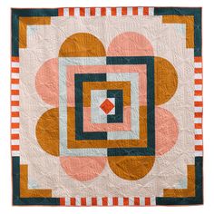 a quilted wall hanging with an abstract design